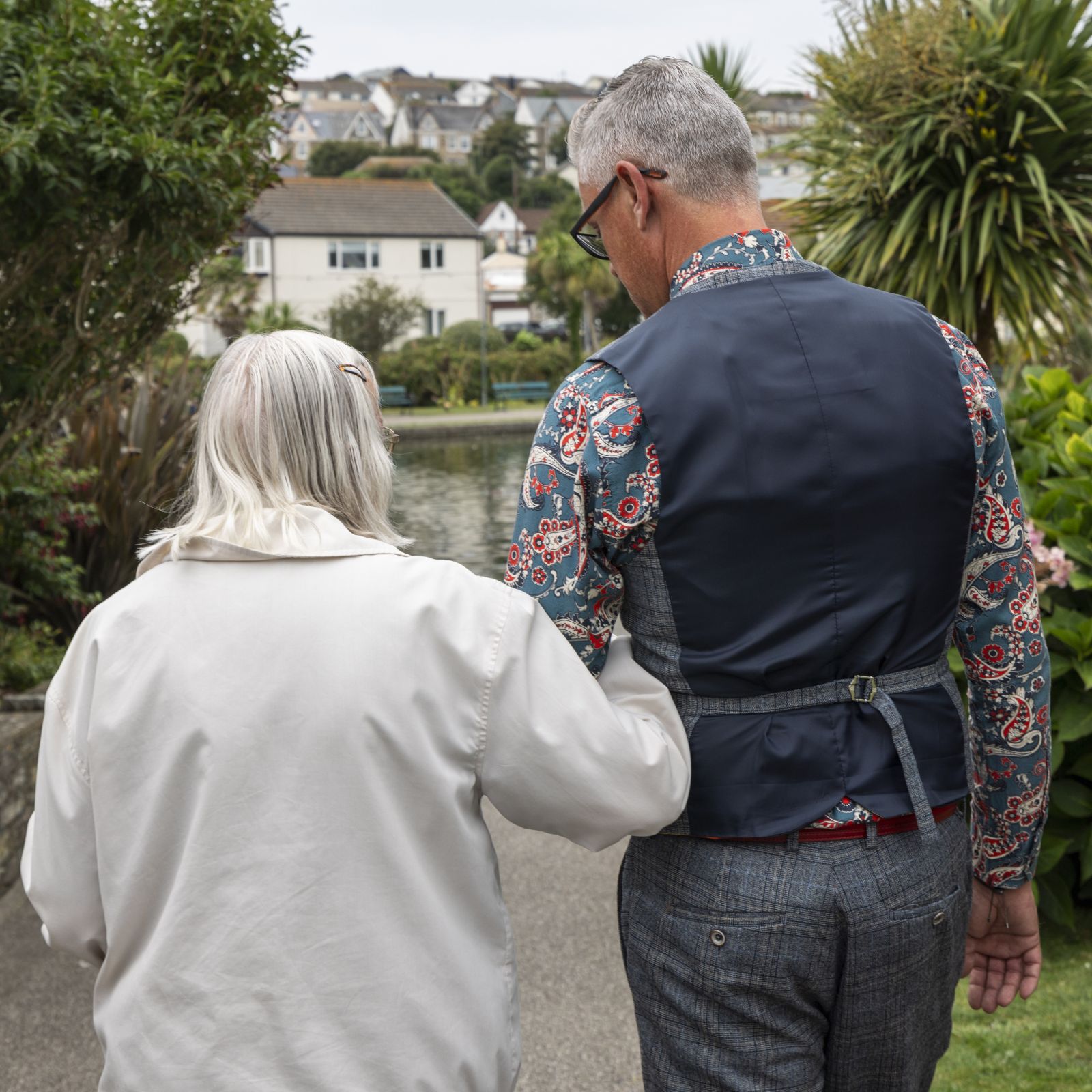 A woman being helped to walk by a man