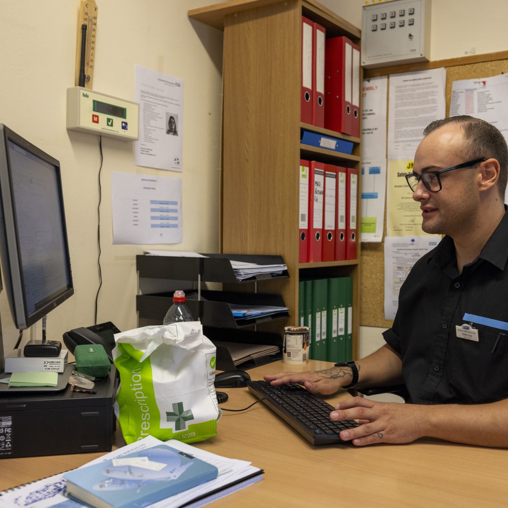 A man sitting at a desk using a computer