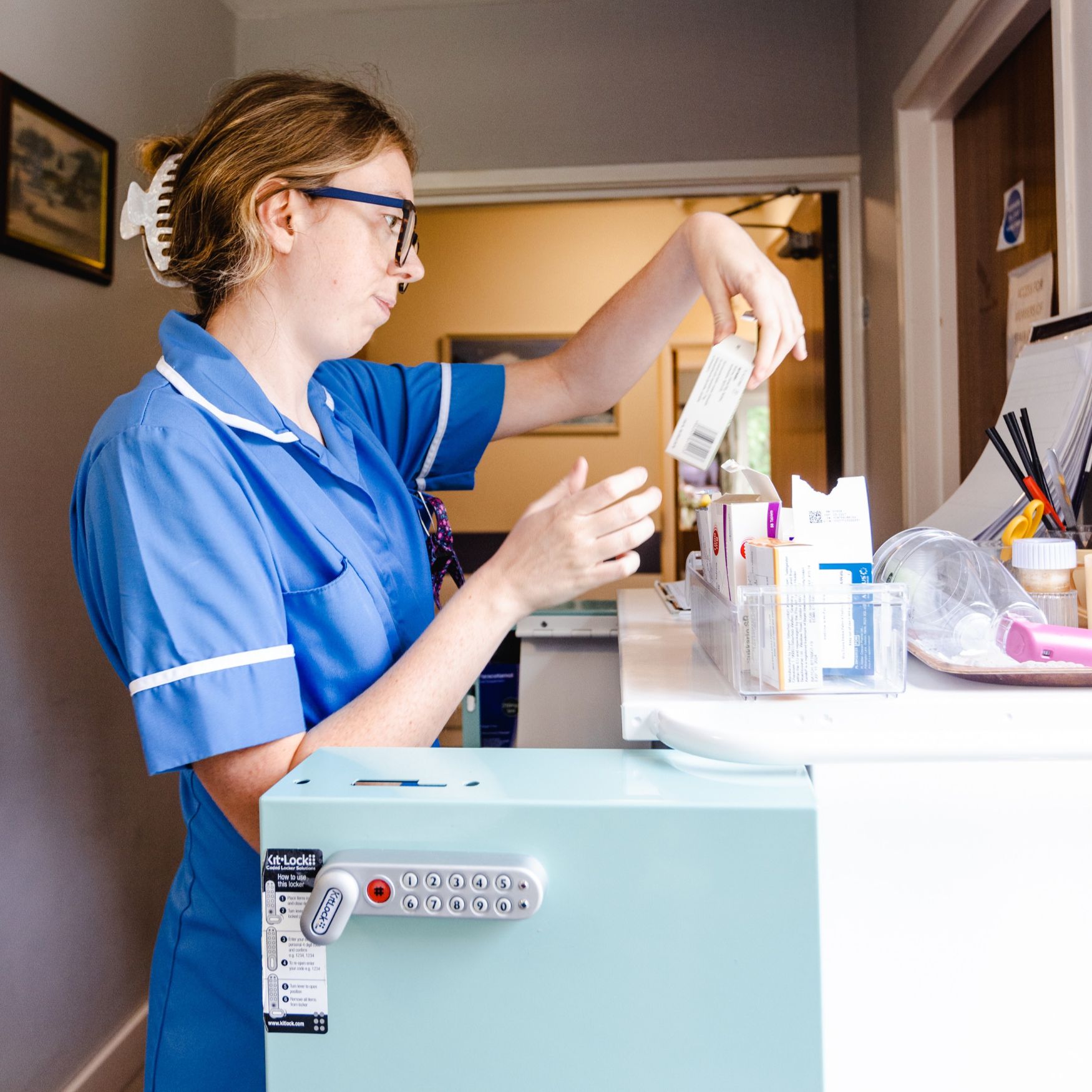 A young female nurse reading a medicine box
